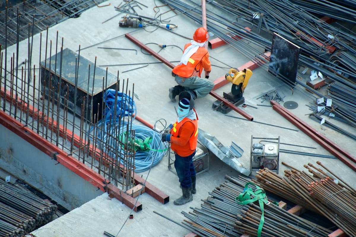 Building materials yard with stacked cement bags and iron rods in Nigeria