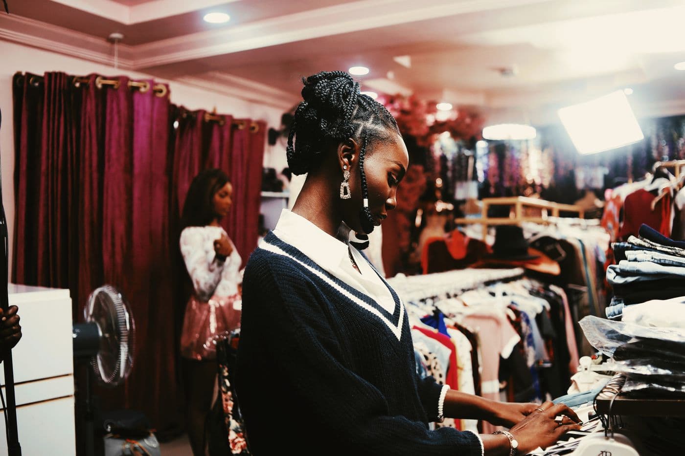 Boutique owner in Abuja managing stock and orders