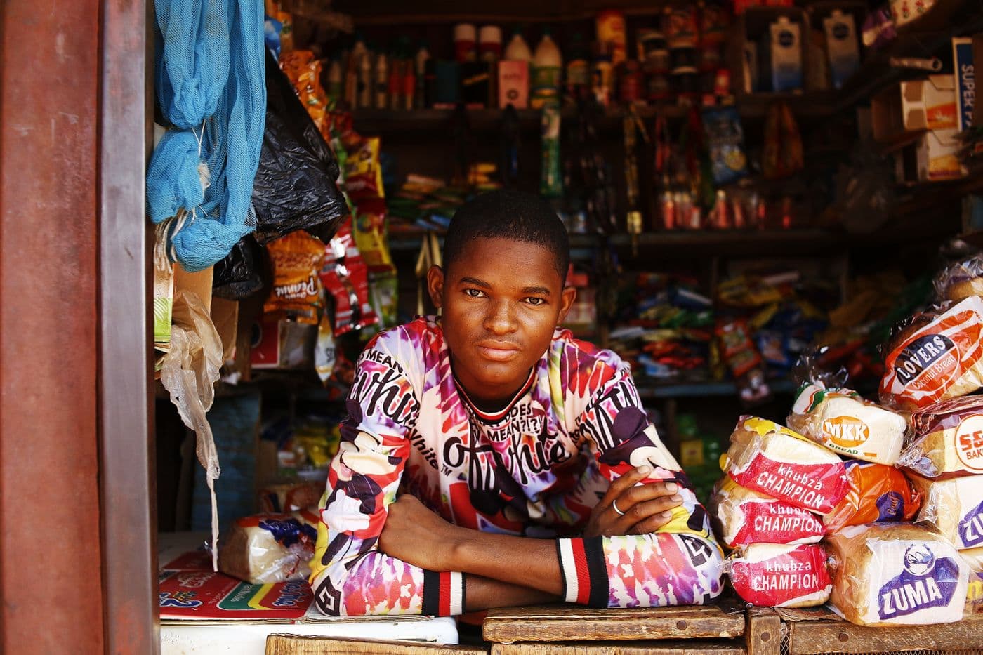 Shop owner in Abuja accepting a payment from a customer