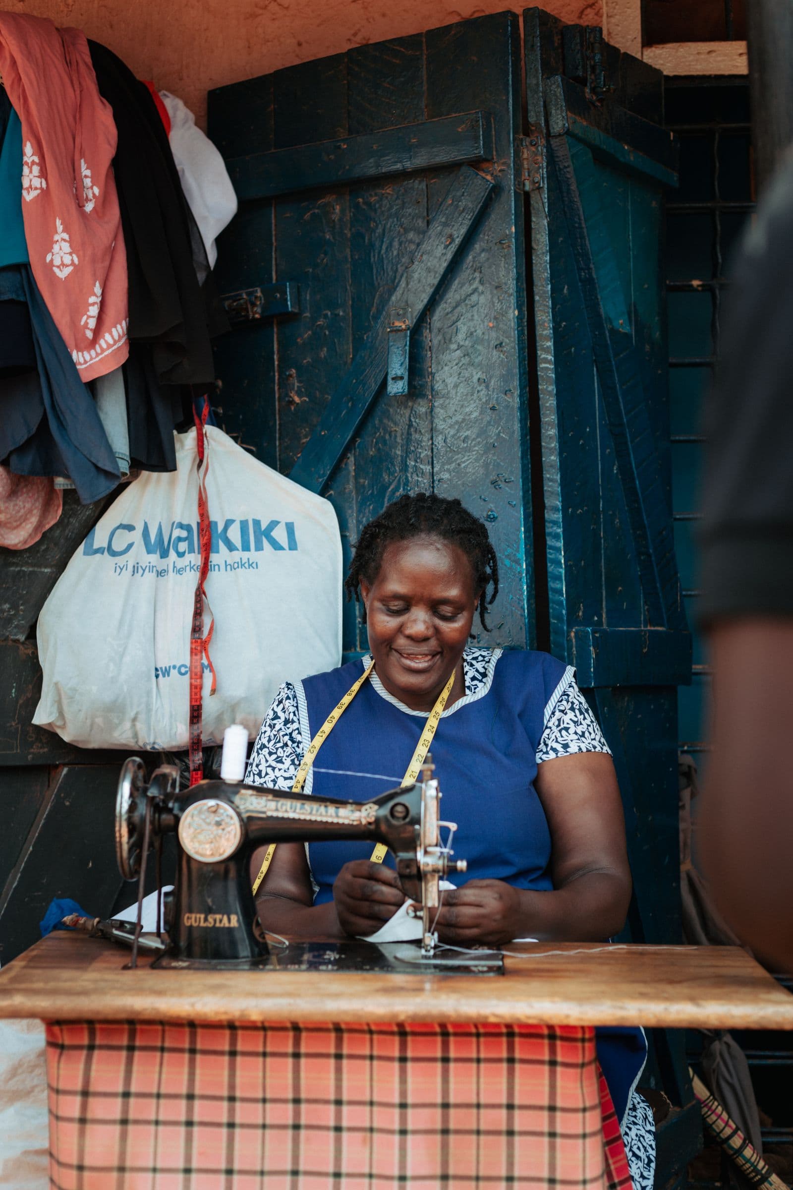 Self-employed seamstress at her sewing machine running a one-person business