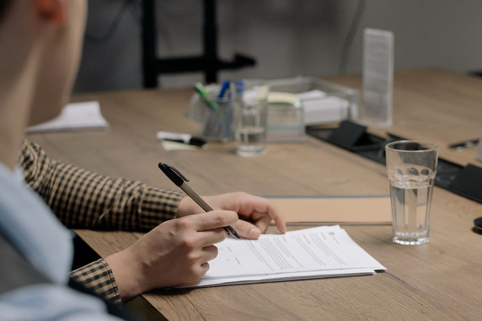 Signing off a document at a desk