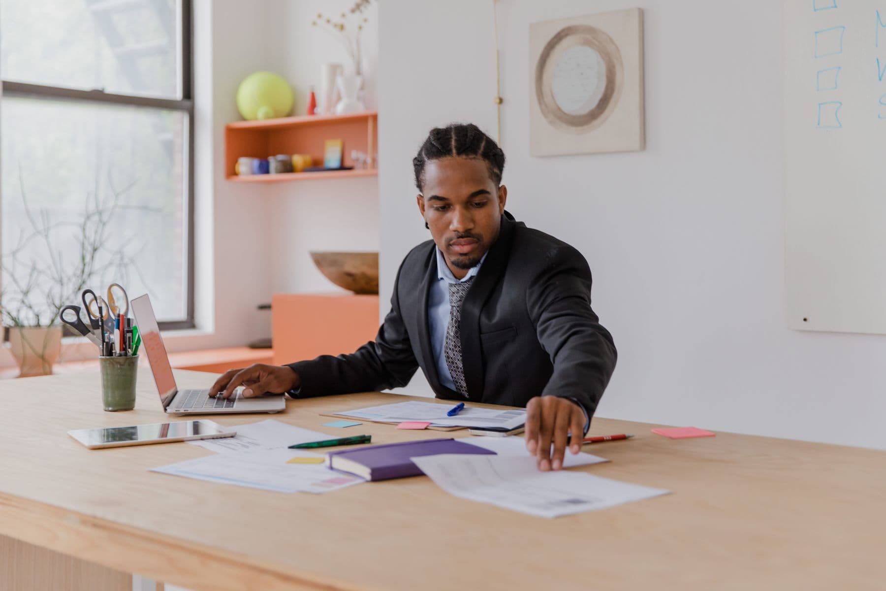 Business owner working through operational documents spread across a desk