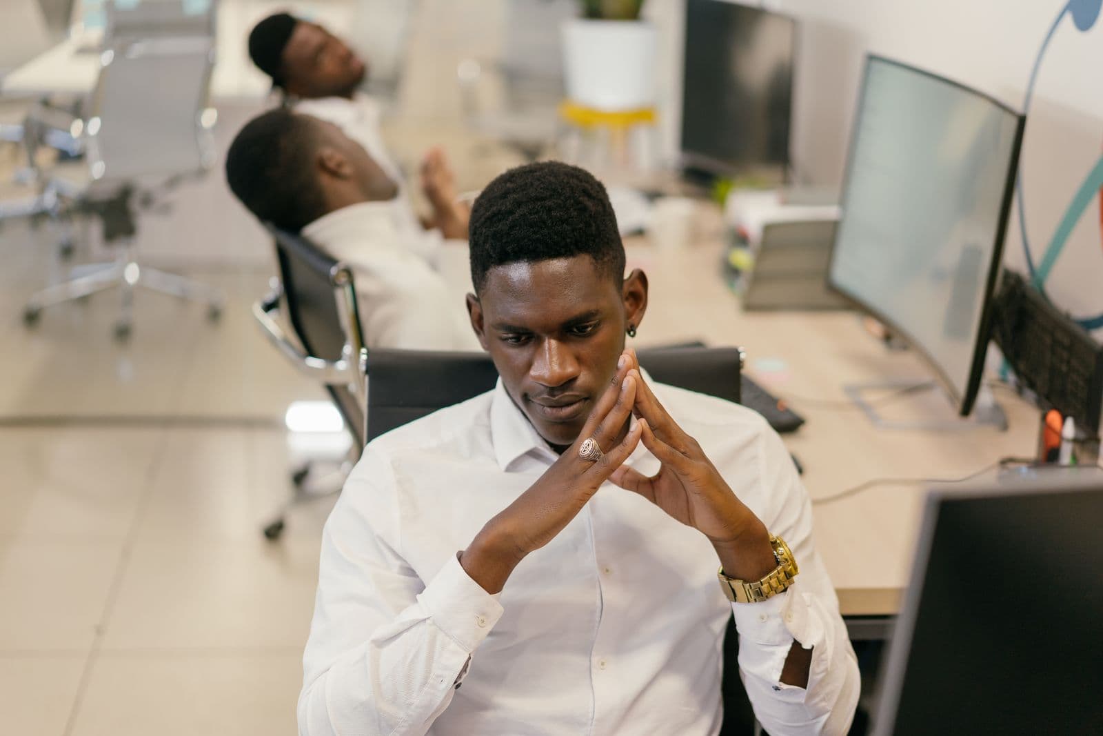 Finance analyst working across multiple screens at an enterprise